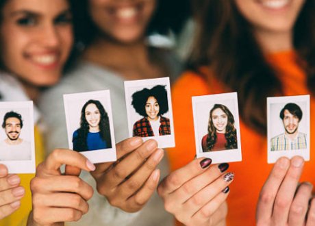 women holding pictures of people